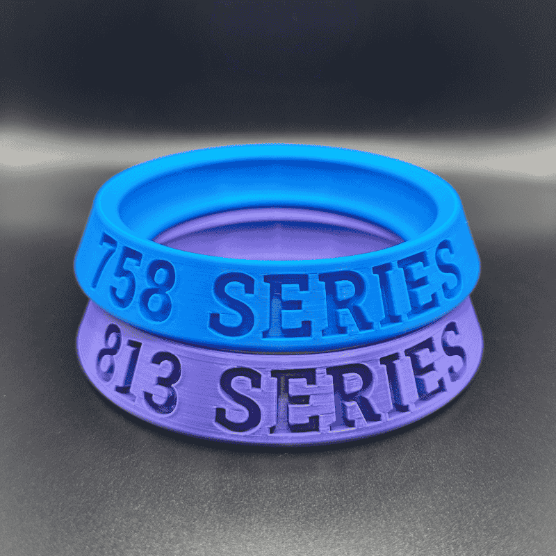 Blue and purple silicone bands with '158 SERIES' and '813 SERIES' text on a dark background