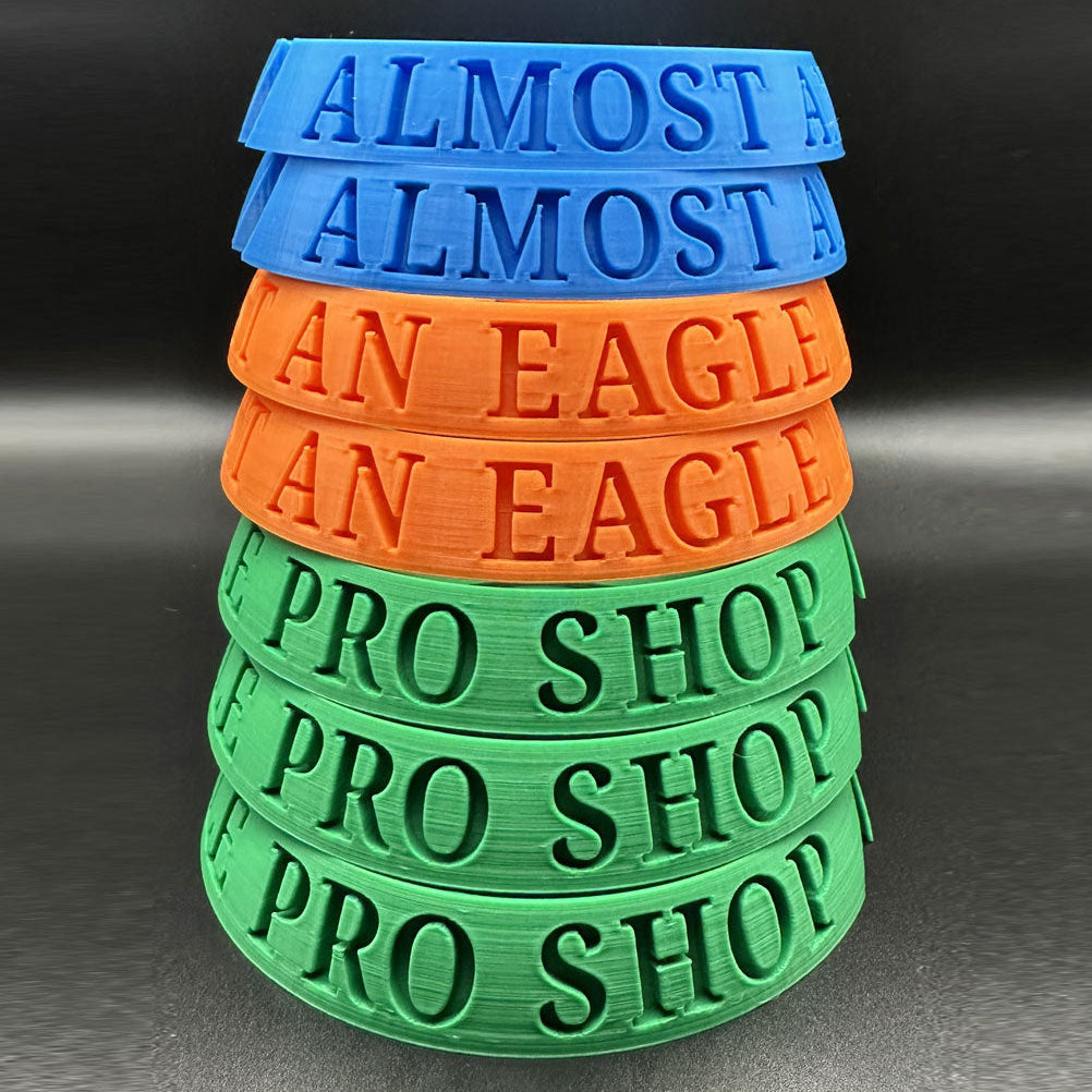 Stack of colorful rubber bands with text on a dark background