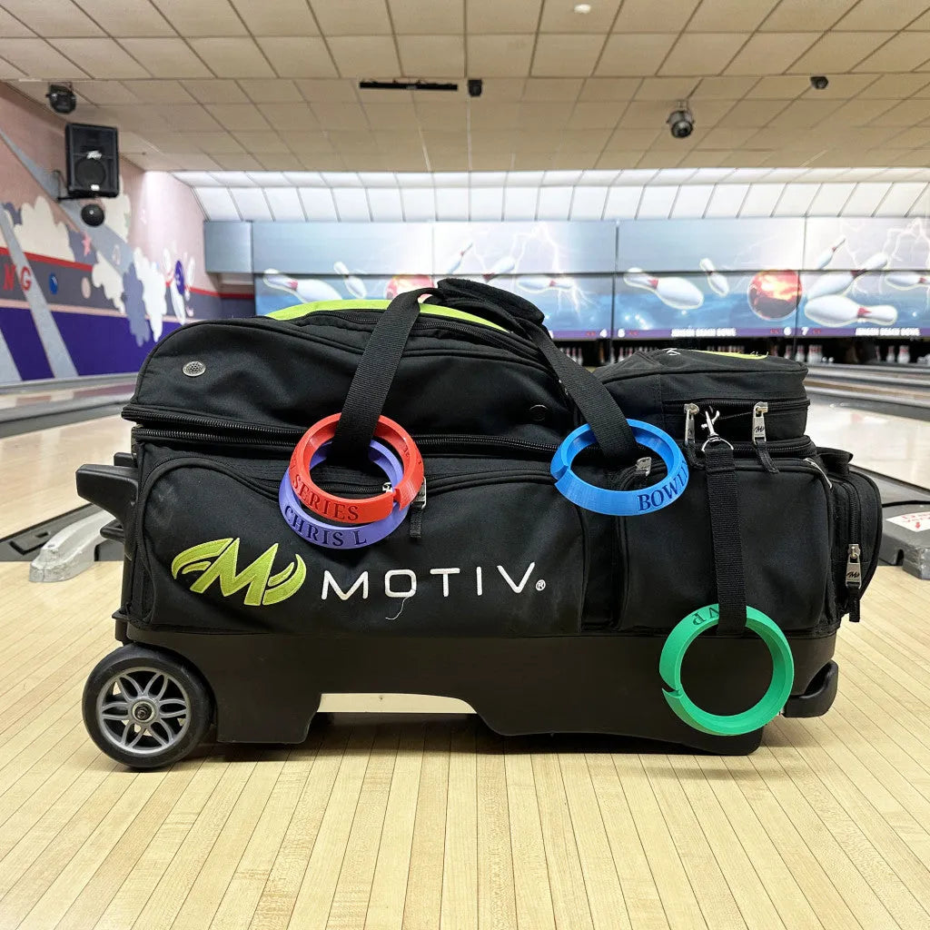 Black bowling bag with colorfulBowling customs rings on a bowling lane