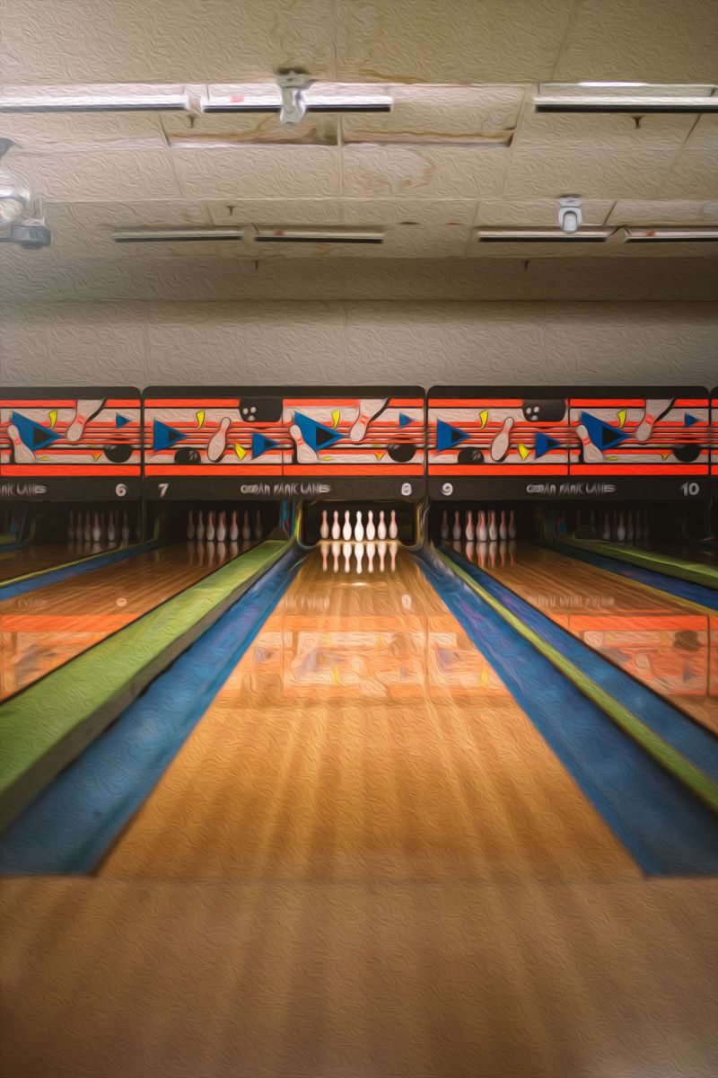 Bowling alley with lanes and pins in a recreational facility.